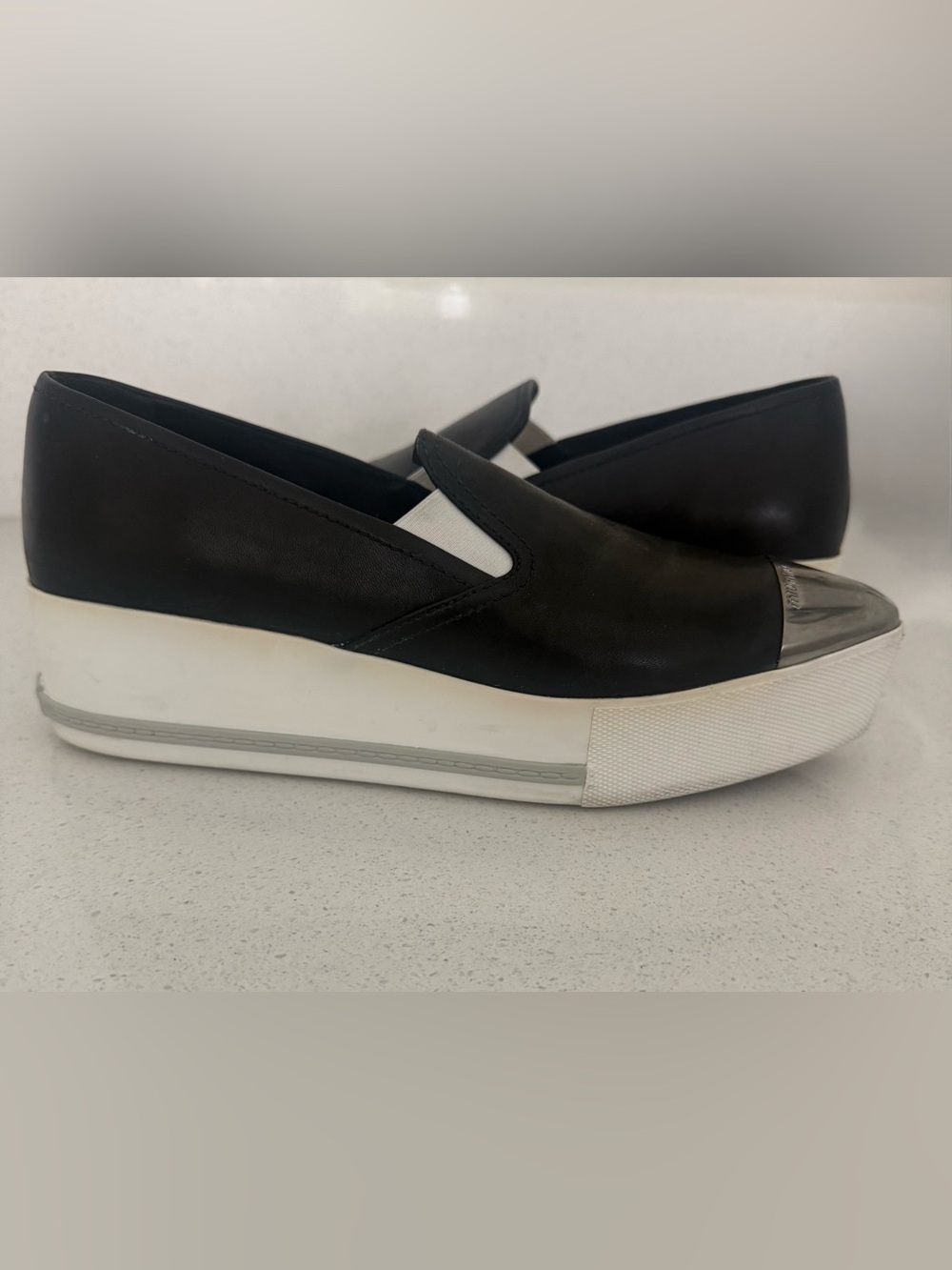 Miu Miu Black Leather Slip-On Sneakers with Silver Cap Toe